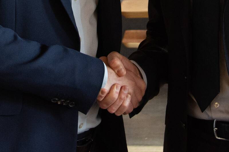 Business partners shaking hands over a deal