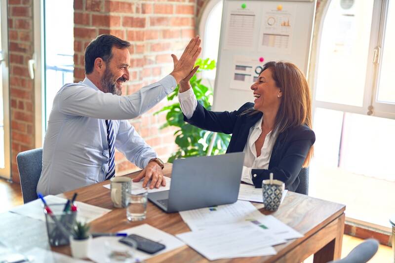 Two advisors in conversation at a meeting table